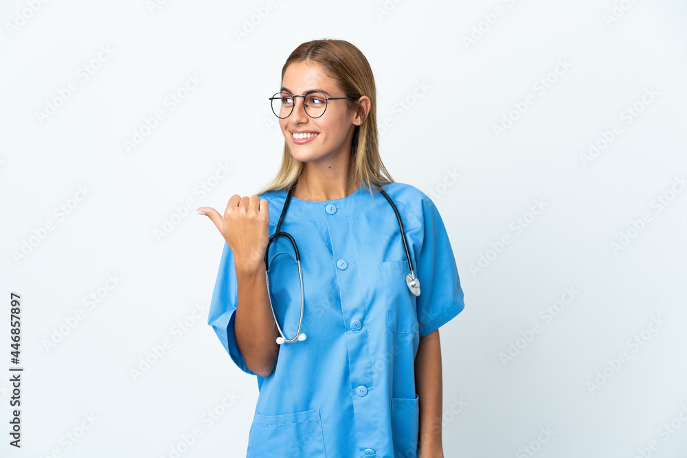 Surgeon doctor woman over isolated white background pointing to the side to present a product Surgeon doctor woman over isolated white background pointing to the side to present a product