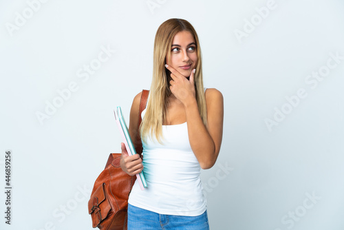 Young student woman isolated on white background looking to the side and smiling