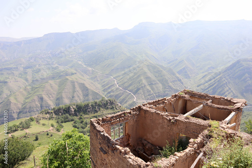 ruined house in abandoned mountain village Gamsutl in Dagestan,Russia with scenic valley view on the background photo