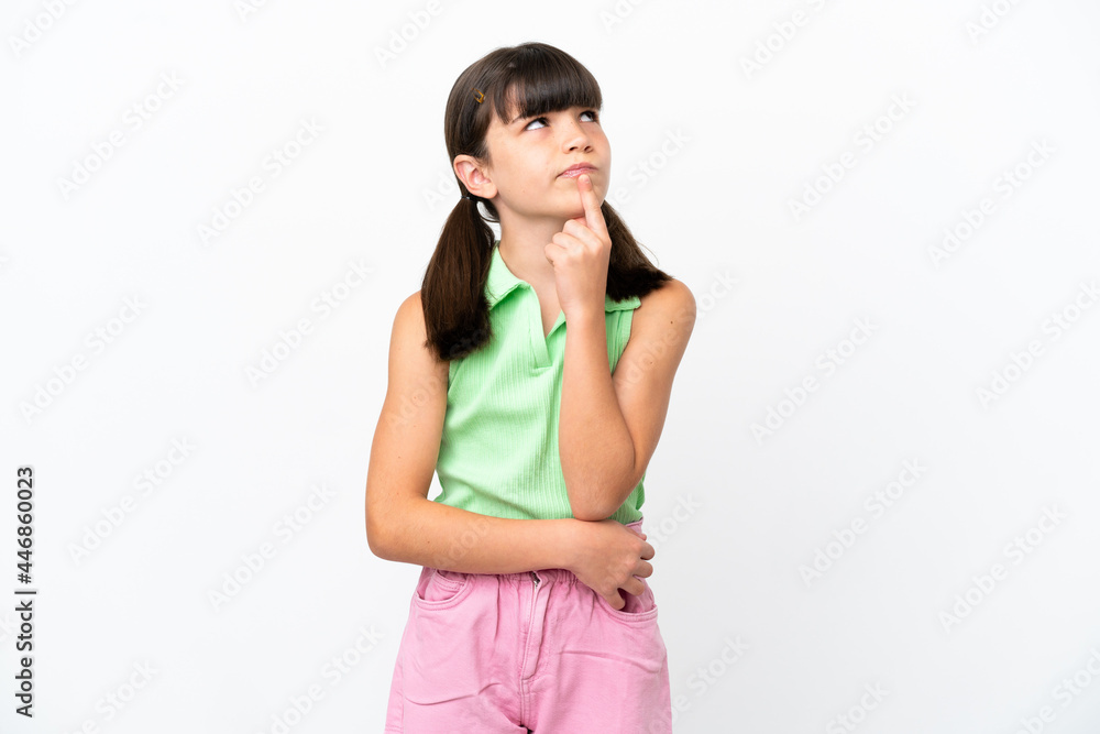 Little caucasian kid isolated on white background having doubts while looking up Little caucasian kid isolated on white background having doubts while looking up