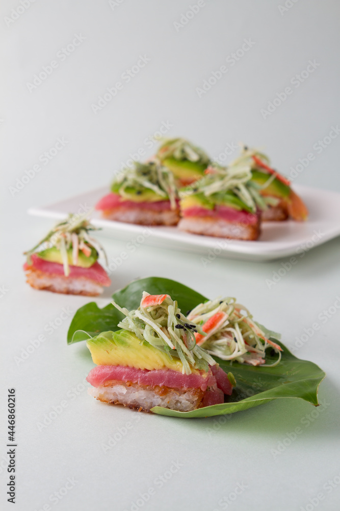 sushi pizza with blue background, leaf plate with neptune salad sushi pizza with blue background, leaf plate with neptune salad