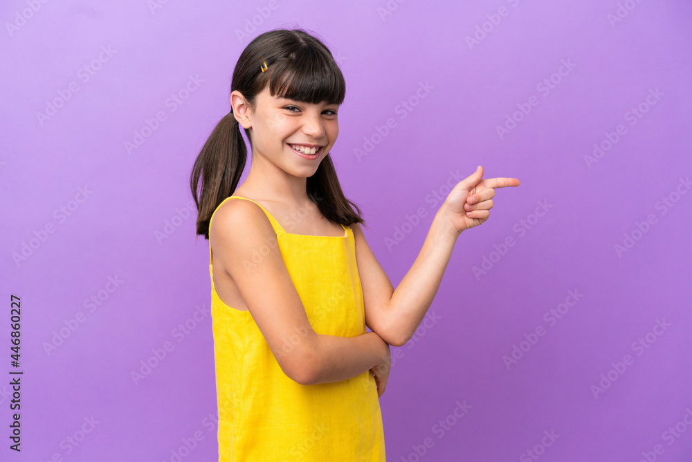 Little caucasian kid isolated on purple background pointing finger to the side Little caucasian kid isolated on purple background pointing finger to the side