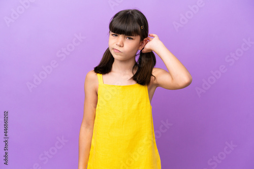 Little caucasian kid isolated on purple background having doubts
