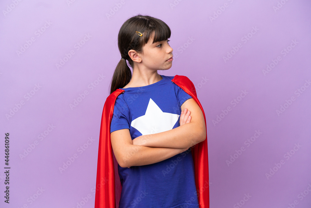 Little kid isolated on purple background in superhero costume with arms crossed Little kid isolated on purple background in superhero costume with arms crossed