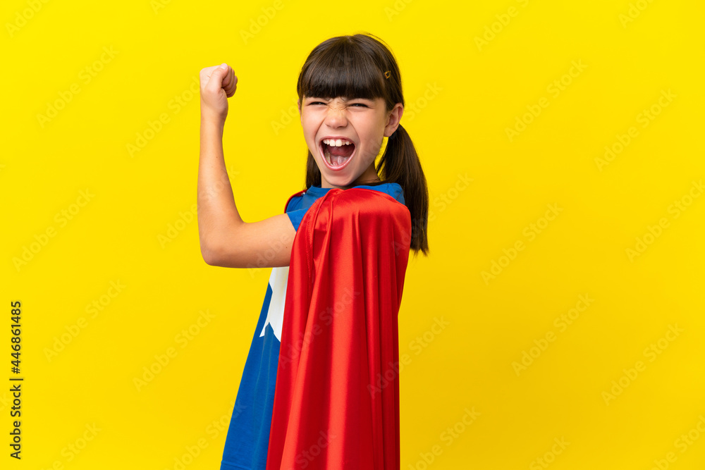 Little super hero kid isolated on purple background doing strong gesture Little super hero kid isolated on purple background doing strong gesture