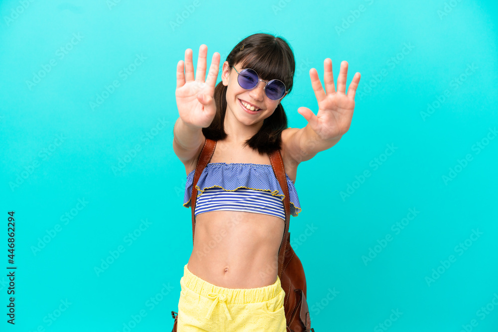 Little caucasian kid going to the beach isolated on blue background counting nine with fingers