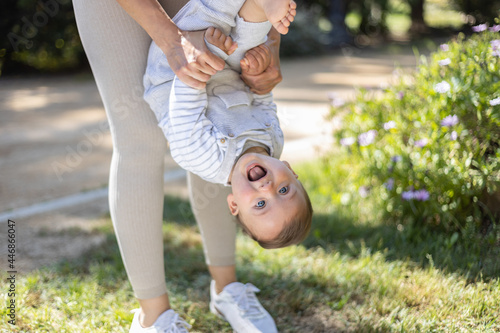 Baby playing with his mother