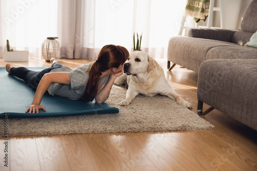 Doing exercise with her lazy dog