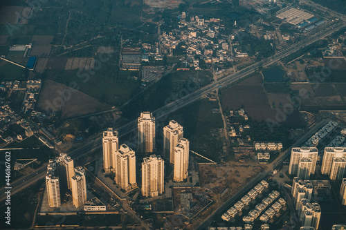 Kathmandu outskirts high buildings and main road against green fields during sunrise while landing at the international airport, Nepal photo