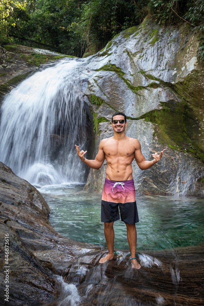 Man enjoying beautiful crystal clear water rainforest waterfall Man enjoying beautiful crystal clear water rainforest waterfall