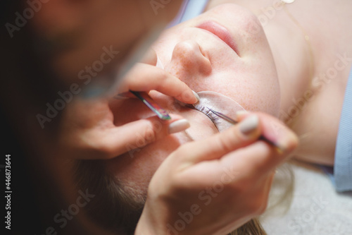 Aesthetic medicine: eyelash extension procedure for young woman