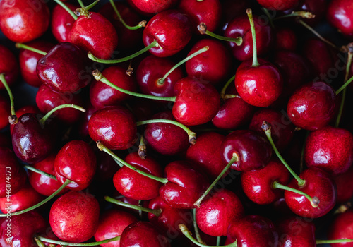 Close up of a bunch of bright red cherries shot from above.