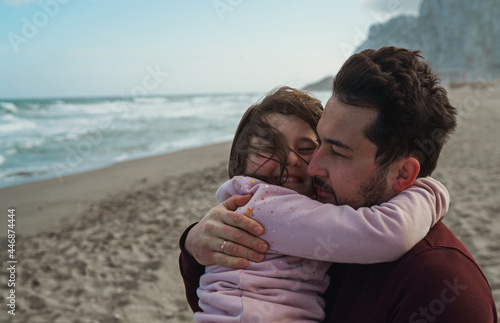 Father and daughter on the ocean shore photo