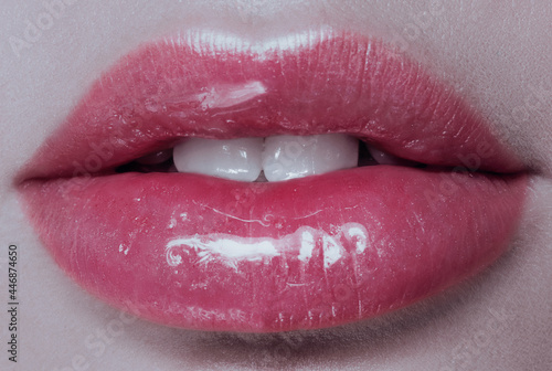 Part of face,young woman close up. plump glossy lips photo