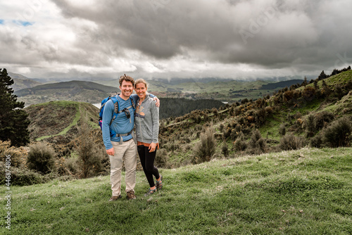 Active middle aged couple in New Zealand standing with mountains in background photo