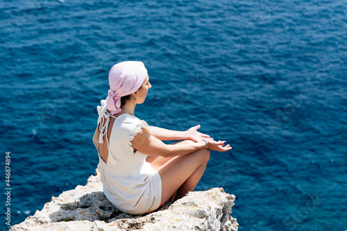 Woman with pink headscarf, has cancer