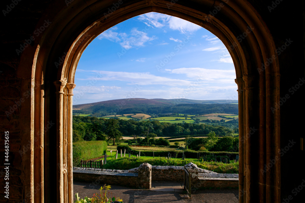 Amaizing view trough the open window. Open window of church with scenic view on green landscape of green fields.  Rolling landscape visible through window frame. Somerset, England.
