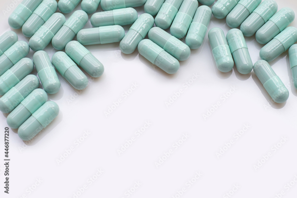 Blue green capsules on white background Blue green capsules on white background