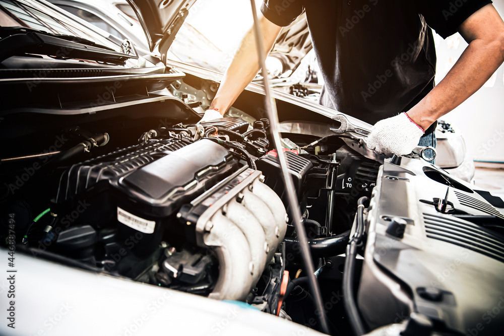 Car care maintenance and servicing, Close-up hand technician auto mechanic using the wrench to repairing change spare part car engine problem. Concepts of check and during periodic inspection service. Car care maintenance and servicing, Close-up hand technician auto mechanic using the wrench to repairing change spare part car engine problem. Concepts of check and during periodic inspection service.