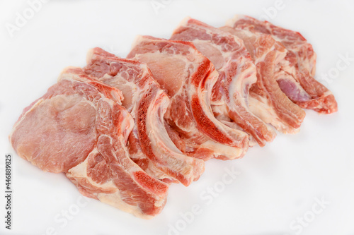 Raw pork chops bone in isoladet on white background.