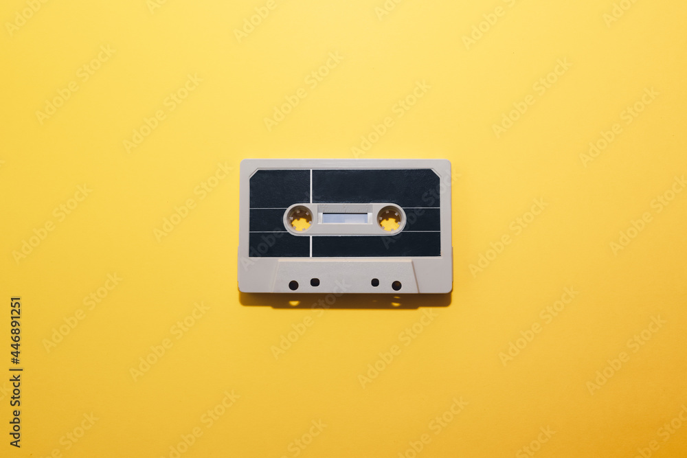 Audio cassette tape isolated on a yellow background