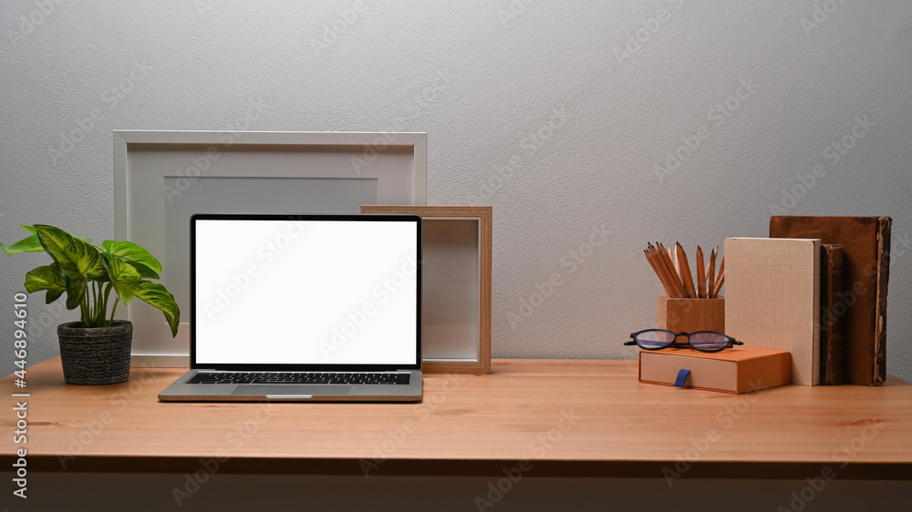 Mock up laptop computer and houseplant on wooden desk. Mock up laptop computer and houseplant on wooden desk.