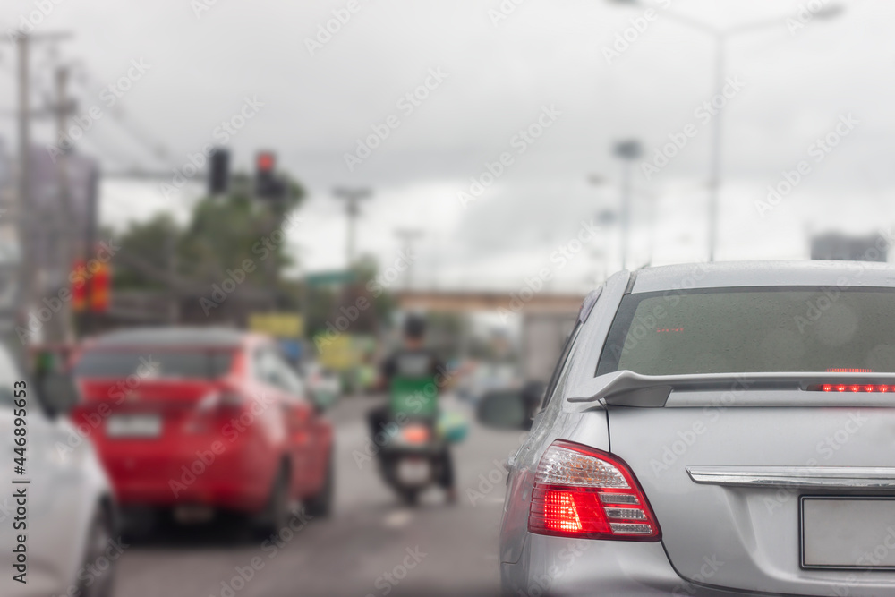 Gray car with raindrops on the road by rush hour or traffic jam in Thailand.