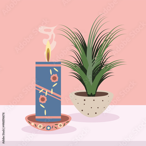 burning candle and houseplant