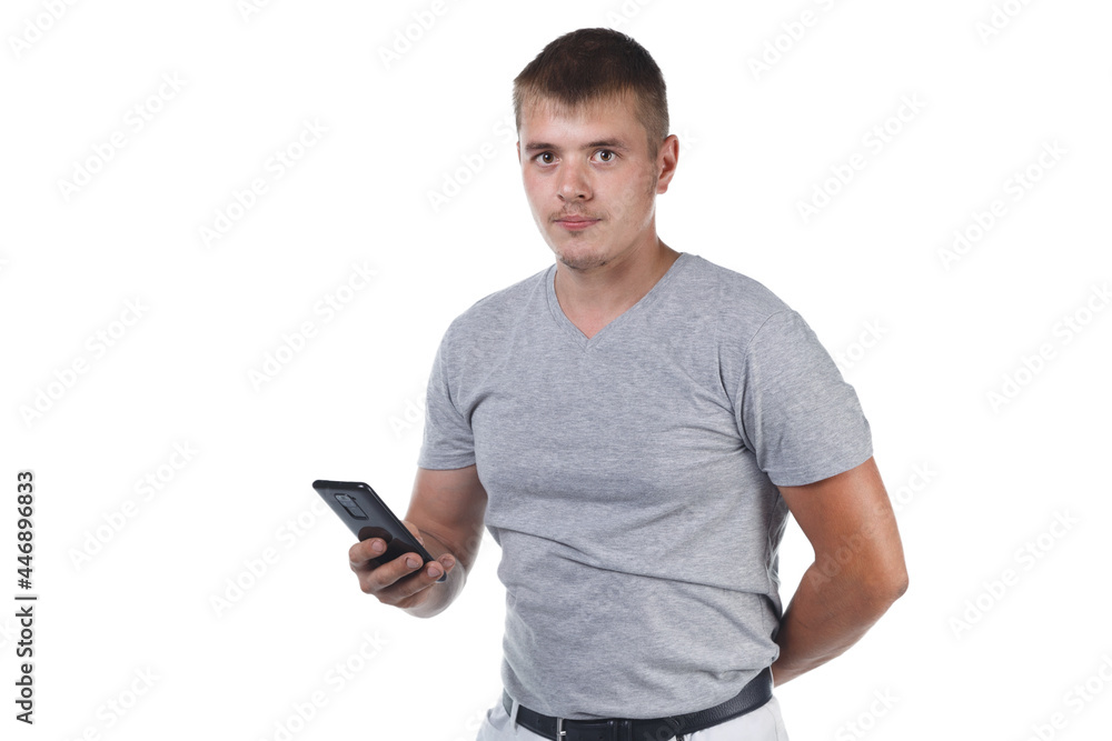 Image of young man with bristle holding smartphone Image of young man with bristle holding smartphone