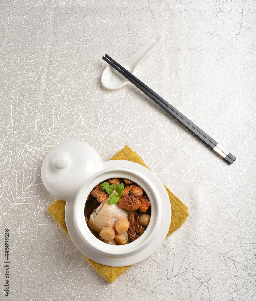 Fototapeta premium chinese superior double boiled truffle seafood scallop fish maw chicken hot soup with herbal in white background asian halal seafood menu