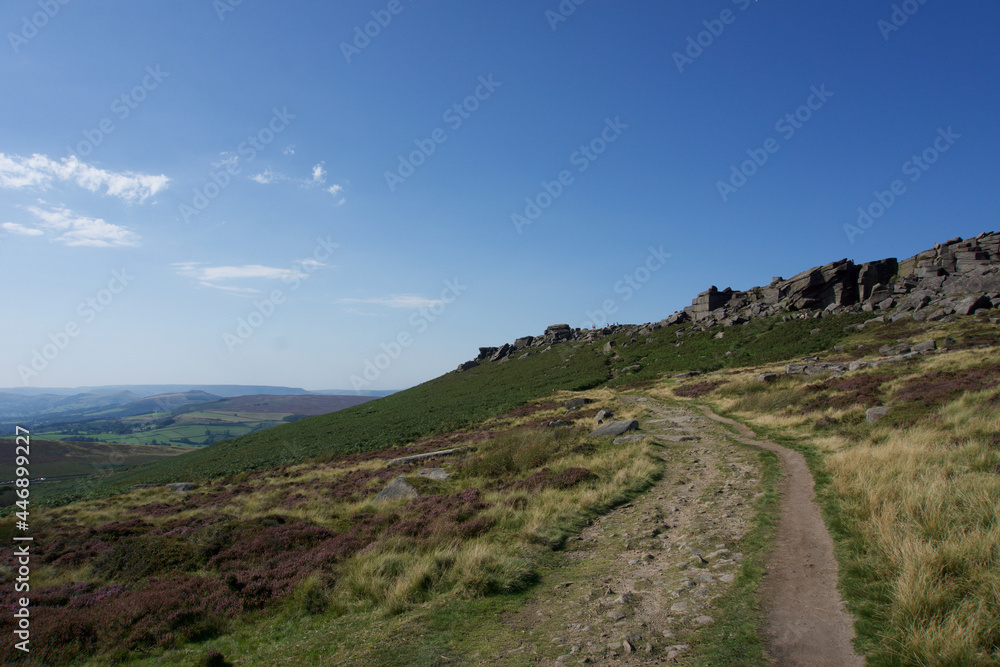 Cliffs of Stanage Edge in Derbyshire Peak District on bright sunny day