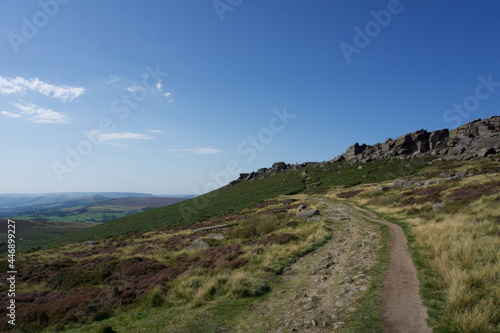 Cliffs of Stanage Edge in Derbyshire Peak District on bright sunny day