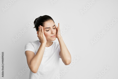 woman in white t-shirt health problems headache stress emotions