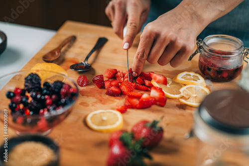 Woman Preparing Fruits for Fermentation. photo