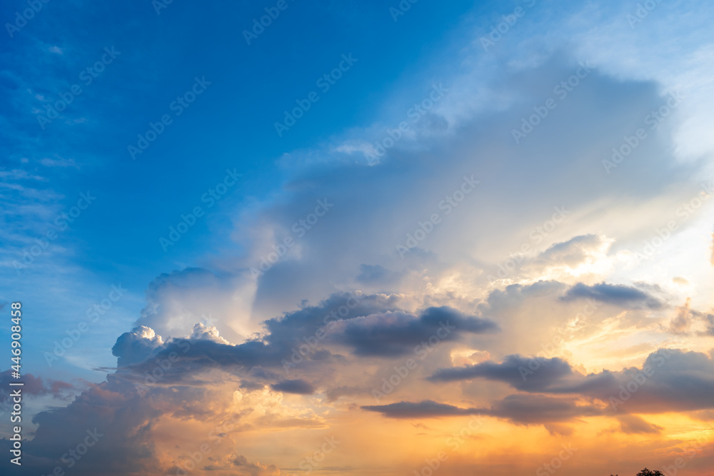 Fototapeta premium Twilight blue bright and orange yellow dramatic sunset sky in countryside or beach colorful cloudscape texture with white clouds air background.