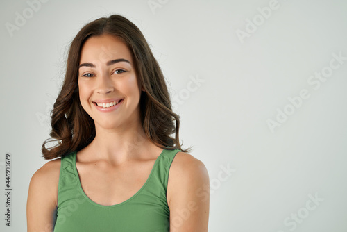 attractive brunette in green t-shirt smile fashionable hairstyle studio