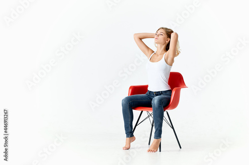 woman sitting on red chairs posing fashion glamor light background