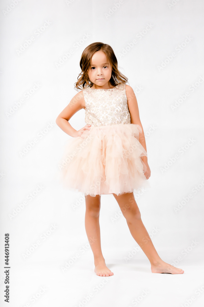 Portrait of happy pretty curly little girl standing and posing over white background Portrait of happy pretty curly little girl standing and posing over white background