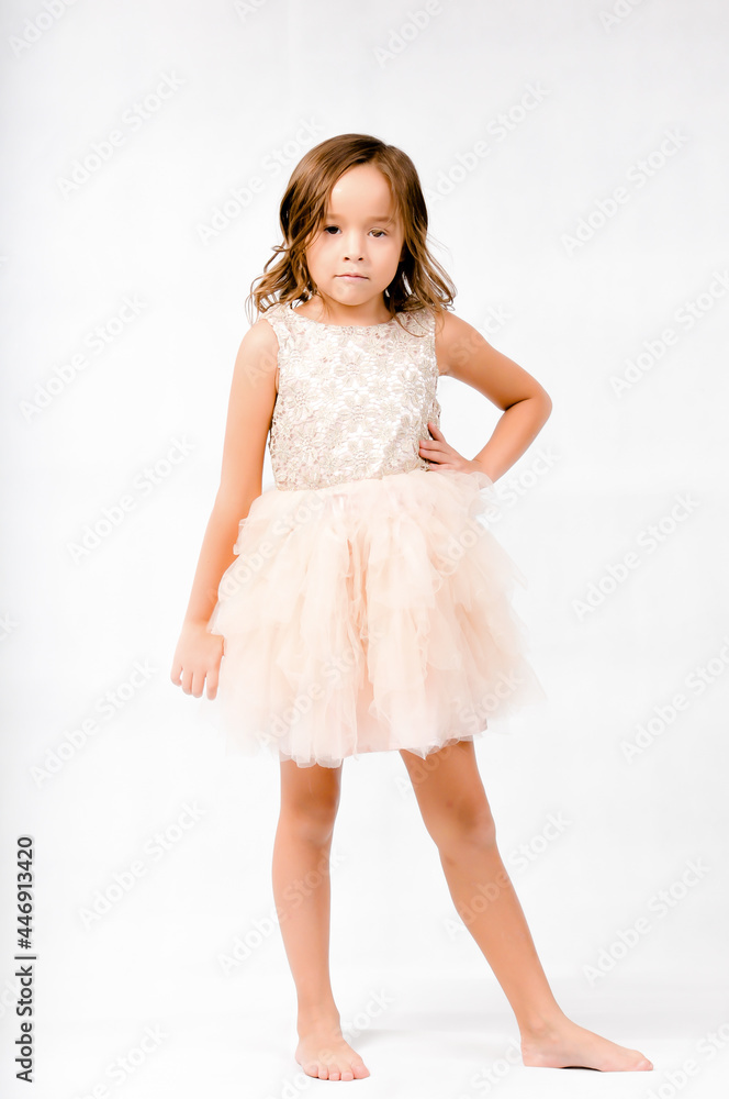 Portrait of happy pretty curly little girl standing and posing over white background Portrait of happy pretty curly little girl standing and posing over white background