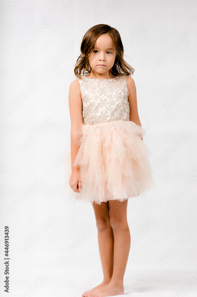 Portrait of happy pretty curly little girl standing and posing over white background Portrait of happy pretty curly little girl standing and posing over white background
