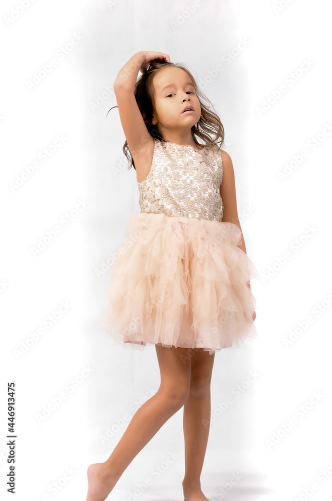 Portrait of happy pretty curly little girl standing and posing over white background Portrait of happy pretty curly little girl standing and posing over white background