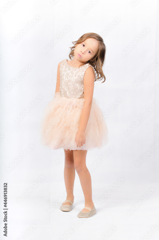 Portrait of happy pretty curly little girl standing and posing over white background Portrait of happy pretty curly little girl standing and posing over white background