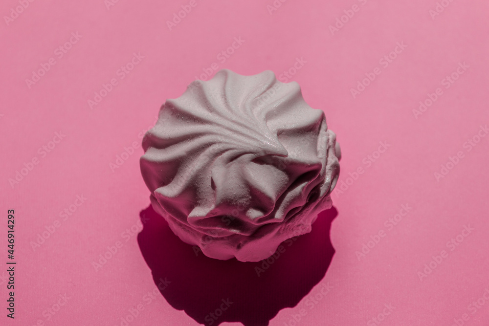 Beautiful textured white marshmallow on a pink background.
