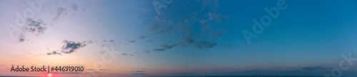 Panorama of the sunset. Orange and blue sky.