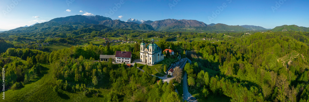Pilgrimage church St. Anne in Tunjice and in background Kamnik - Savinja Alps, Slovenia