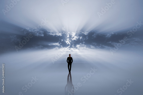 Man walking alone towards the light