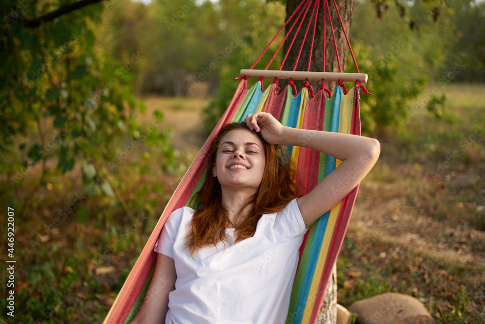 Fototapeta premium joyful woman in nature lies in a hammock rest Comfort