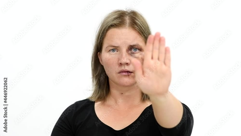 Woman victim of domestic violence and abuse showing a stop sign. Isolated on white background Woman victim of domestic violence and abuse showing a stop sign. Isolated on white background