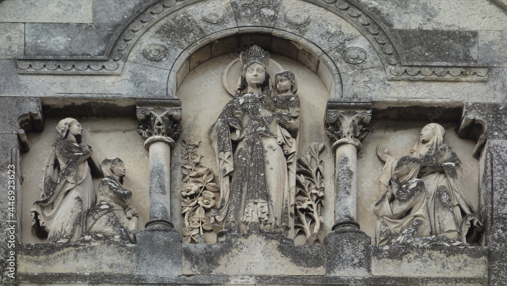 marble embossed carved facade from a statue with the crowned Virgin Mary under arches, La Rochelle, Bay of Biscay, France