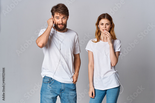 young couple listening to music in white t-shirts fun